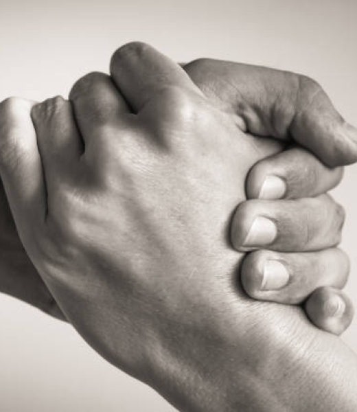 Close up image of a man giving a helping hand to a woman.